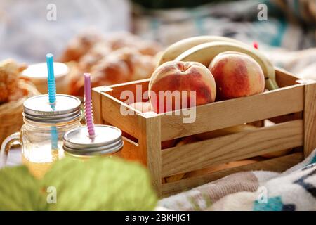 Picknick im Park. Nahaufnahme von frischem Obst, eiskalten Sekt an einem heißen Sommertag. Picknick-Mittagessen. Selektiver Fokus. Stockfoto