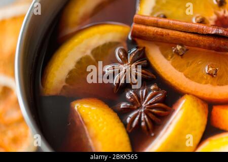 Topf mit heißem Glühwein, Orangenscheiben und Gewürzen Stockfoto