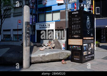 Tokio, Japan - Goldene Woche Urlaub, 2. Mai 2020 :Obdachloser Mann genießt das Lesen von Zeitungen in Shinjuku Stockfoto