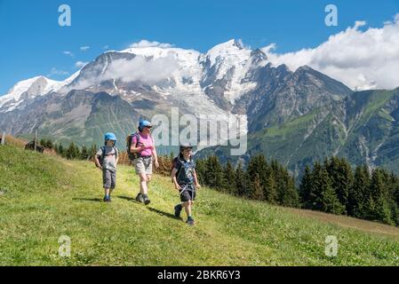 Frankreich, Haute-Savoie (74), Saint-Gervais, le Prarion, Wanderer, die zum Chalet La Charme mit dem Mont-Blanc-Massiv im Hintergrund hinabsteigen (MR) Stockfoto