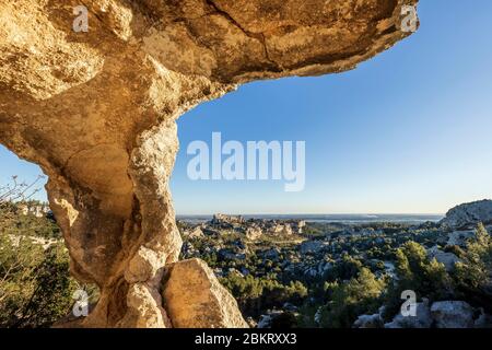 Frankreich, Bouches-du-Rh?ne, Alpilles regionaler Naturpark, Les Baux de Provence, beschriftet Les Plus Beaux Villages de France, Val d'Enfer, Klippe durchbohrt von Höhlen, das Dorf und das Schloss in Ruinen hinter -Plan Stockfoto