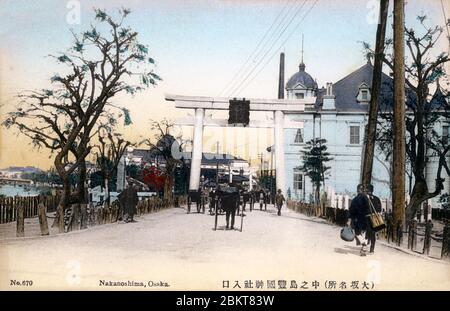 [ 1900er Japan - Torii in Nakanoshima, Osaka ] - Heilige Torii Tor in Hokoku Jinja, gewidmet Toyotomi Hideyoshi (1536 oder 1537-1598) auf Nakanoshima, Osaka. Das Gebäude auf der rechten Seite ist das Osaka Hotel. Vintage-Postkarte des 20. Jahrhunderts. Stockfoto