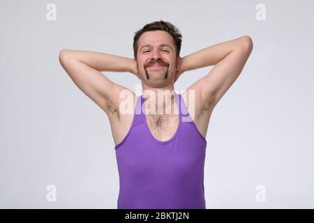 Angenehm attraktiv Inhalt fröhlicher Mann mit lustigen Schnurrbart stolz auf sich selbst. Studioaufnahme Stockfoto