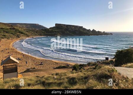 Blick auf schöne Bucht mit Sandstrand Meer oder Meer ist ein blau türkis mit weißen Wellen. Strand umgeben Steinhügel Stockfoto