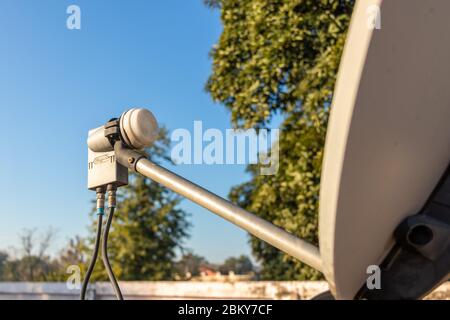 LNB, Satellitenschüssel über dem blauen Himmel im Hintergrund, selektiver Fokus. Stockfoto