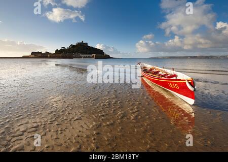 Ein Cornish Gig Boot, das am Strand von Marazion auf dem Sand ruht Stockfoto