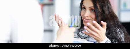 Frau im Büro hilft Mann, richtige Entscheidung zu kommen Stockfoto