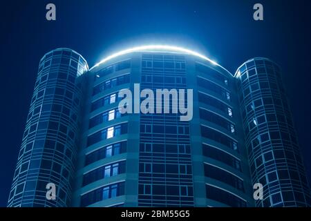 Odessa, Ukraine - April 03 2020: Bodenaufnahmen moderner Stadtbau mit Neonlicht gegen den Nachthimmel Stockfoto