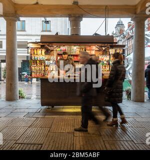 Covent Garden Street Trader. Aufgeschlossen einkaufen gehen an einem hell beleuchteten Marktstand Inhaber im Herzen von Londons West End Touristenviertel. Stockfoto