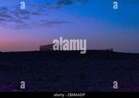 Silhouetten von Hütten in der Danakil Wüste in der Dämmerung, Äthiopien Stockfoto