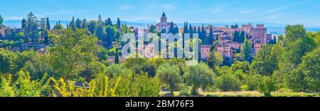 Beobachten Sie das Panorama der Alhambra Festung mit Türmen, Wällen, Alcazaba und Santa Maria Kirche, umgeben von üppigem Grün, Granada, Spanien Stockfoto