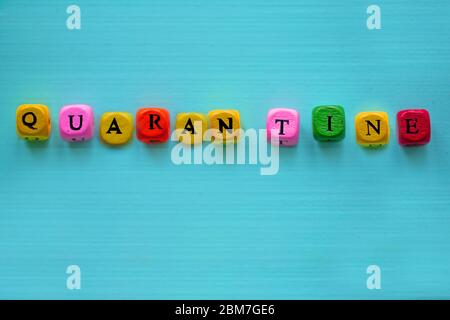 Wort Quarantäne mit Würfel auf buntem Hintergrund, konzeptionell. Stockfoto