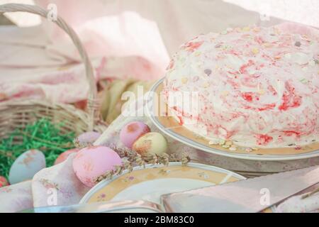Osterdekoration. Hausgemachter Erdbeerkuchen. Osterkorb mit Eiern. Stockfoto