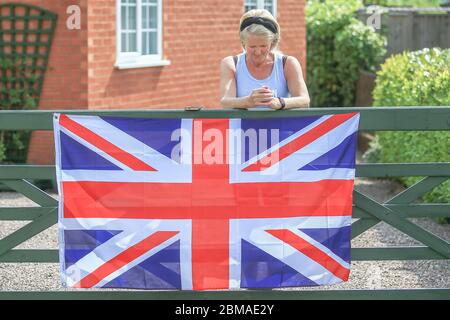 Hunnington, Worcestershire, Großbritannien. Mai 2020. Während Großbritannien den 75. Jahrestag des VE Day feiert, beugt sich eine Dame zu Ehren der Schweigeminute im Dorf Hunnington, Worcestershire, den Kopf. Quelle: Peter Lopeman/Alamy Live News Stockfoto