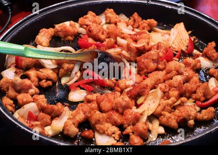 Chinesisches Wok-Essen in London. Gebratenes Hähnchen mit Zwiebeln und Paprika. Stockfoto