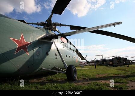 Außenansicht eines Mil Mi-6 'Hook' Super-Schwerlasthubschrauber, der nebeneinander mit einem Mi-8 'Hip' im Zhulyany State Aviation Museum der Ukraine geparkt ist Stockfoto