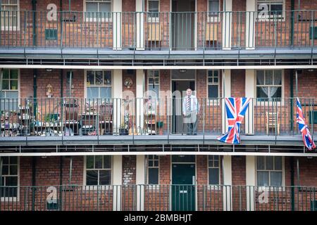 Manchester, Großbritannien. Mai 2020. Die Bewohner von Ancoats kommen für die nationale zweiminütige Stille, die um 11:00 Uhr stattfand. Die Zeit ist eine Gelegenheit, zu innehalten und zu reflektieren, an die verlorenen Leben und Opfer in Kriegszeiten zu erinnern. Heute jährt sich das Ende des Zweiten Weltkriegs zum 75. Mal, als Großbritannien und seine Verbündeten Nazi-Deutschland besiegten. Aufgrund der COVID-19 mussten die Feierlichkeiten dieses Jahr an soziale Distanzierungsmaßnahmen zum Schutz der Bevölkerung nach Todesfällen im Landkreis auf über 30000 angestiegen sein. Kredit: Andy Barton/Alamy Live News Stockfoto