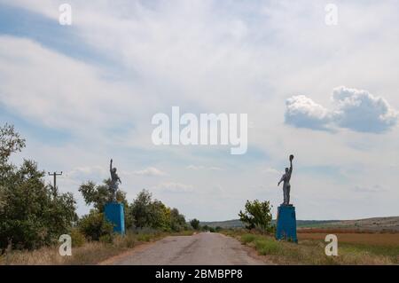 Silhouetten von Arbeiter und Kolchose Frau Stil Statuen an Straßenrändern. Sozialrealismus Denkmäler in der Landschaft der Ukraine Stockfoto
