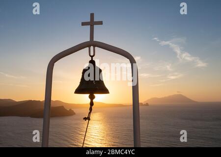 Sonnenuntergang über einer griechisch-orthodoxen Kirchenglocke in der Thalassitra Kirche, Plaka, Milos, Kykladen Inseln, Griechenland Stockfoto