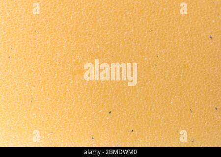Hellorange Textur eines Schwamms. Nahaufnahme hellorange Textur. Hintergrund. Stockfoto