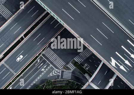 Luftaufnahme des Einzelwagens fährt auf der leeren Autobahn und Überführung in der Stadt Stockfoto