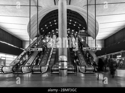 London, England, Großbritannien - 10. März 2020: Pendler fahren mit Rolltreppen an einem der Eingänge zur modernen Canary Wharf U-Bahnstation in Londons Docklands Stockfoto