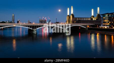 London, England, Großbritannien - 20 August 2013: Die Ikonischen Schornsteine der aufgegebenen Battersea Power Station bei nachts beleuchtet, die vor einem hellen Mond, als South Stockfoto