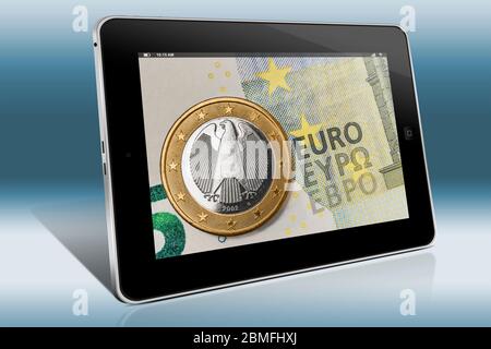 Eine 1-Euro-Münze aus Deutschland auf einer 5-Euro-Banknote, Blick auf einen Tablet PC Stockfoto