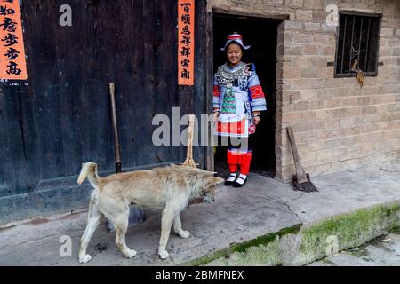 Junges Mädchen mit ihrem Hund. Sie gehört zu den Gejia-Minderheitenvakern. Matang Dorf, Kaili Gebiet, Guizhou Provinz, China Stockfoto