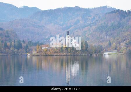 Die berühmte Insel mit Kirche am Bleder See liegt in der Mitte des Sees. Die Wallfahrtskirche Maria in der Mitte des Bleder Sees. Stockfoto