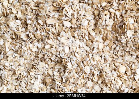 Haferflocken Textur Hintergrund. Hafer aus Vollkorn frisch. Nahaufnahme von Getreide. Gesundes Essen Konzept. Hafer trocken. Müsli zum Frühstück. Draufsicht. Stockfoto