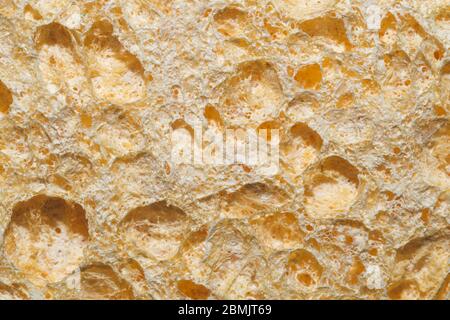 Poröse Materialstruktur aus nächster Nähe. Raue Oberfläche. Abstrakter Hintergrund Stockfoto