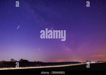Milky way over german autobahn with lightstreaks on very clear night Stockfoto
