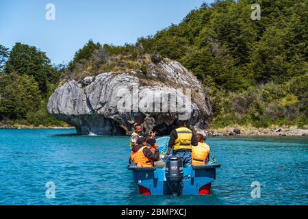 Touristen erkunden die Marmorhöhlen (spanisch: Cuevas de Marmol ), eine Reihe von natürlich geformten Höhlen und Felsformationen in Patagonien, Chile. Stockfoto