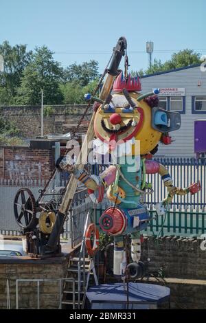 Clownskulptur aus Schrott neben einer Bootswerft am Ufer der Calder, gegenüber dem Eingang zur Hepworth Gallery. Stockfoto