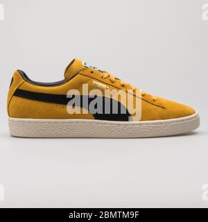 WIEN, ÖSTERREICH - 19. FEBRUAR 2018: Puma Suede Classic Archive Turnschuh gelb und schwarz auf weißem Hintergrund. Stockfoto
