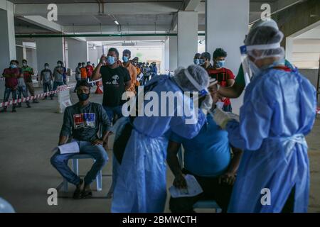 Cyberjaya, Malaysia. Mai 2020. Das Gesundheitspersonal hat eine Probe auf Bauarbeiter während des Free Coronavirus Screening Test auf der Baustelle hier in Cyberjaya, Selangor außerhalb Kuala Lumpur genommen. Malaysia. Bauunternehmen, die während der MCO-Zeit (Movement Control Order) tätig werden dürfen, müssen sicherstellen, dass ihre Mitarbeiter Covid-19-frei sind oder höhere Betriebskosten anfallen. (Foto: Zulfadhli Zaki/Pacific Press) Quelle: Pacific Press Agency/Alamy Live News Stockfoto