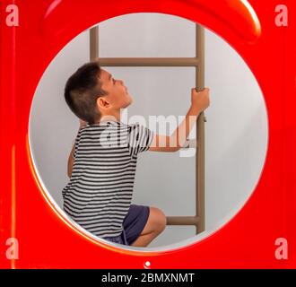 Portrait von asiatischen Jungen sind die Leiter in den Spielplatz. Stockfoto