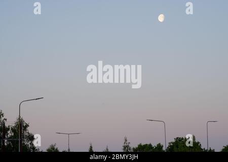 Mond- und Straßenbeleuchtung am Anfang des britischen Konzepts früher Beginn der Arbeit auf dem Weg zur Arbeit Stockfoto