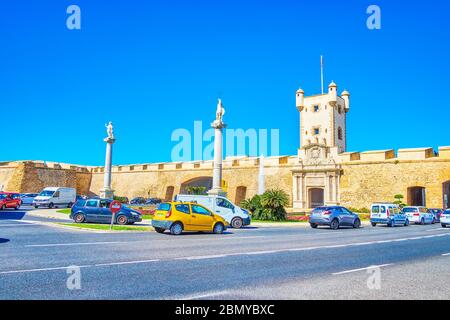 CADIZ, SPANIEN - 24. SEPTEMBER 2019: Der Verkehr auf der Plaza de la Constitucion mit mittelalterlichen Toren der Puerta de Tierra mit erhaltenen Mauern, am 24. September Stockfoto