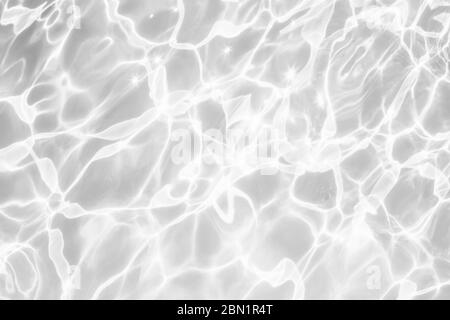 Nahaufnahme der entsättigte transparente klare ruhige Wasseroberfläche Textur mit Spritzern und Blasen. Trendy abstrakt Natur Hintergrund. Stockfoto