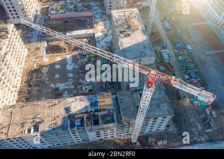Luftaufnahme von Baukräne und einem im Bau befindlichen mehrstöckigen Gebäude in einem Wohngebiet der Stadt Stockfoto