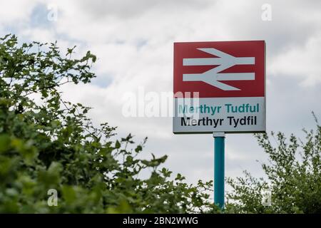 MERTHYR TYDFIL, WALES - 11. MAI 2020 - Merthyr Tydfil Bahnhofsschild in Englisch und Walisisch. Stockfoto