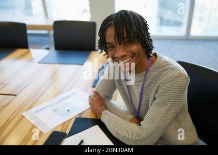 Portrait zuversichtlich Geschäftsmann mit Papierkram im Konferenzraum Stockfoto