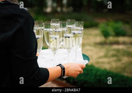 Foto eines Kellners, der Champagnergläser serviert Stockfoto