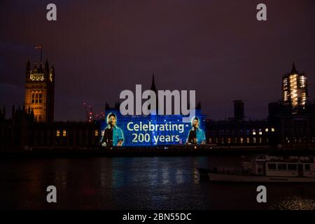 London, Großbritannien. Mai 2020. Ein Bild der Florence Nightingale und einer zeitgenössischen Krankenschwester wird auf die Parlamentsgebäude gegenüber dem St. Thomas' Hospital projiziert (wo sie arbeitete), da es heute vor 200 Jahren der Internationale Tag der Krankenschwestern ist, an dem sie geboren wurde. Die Botschaft ist auch eine Unterstützung für die Krankenschwestern, die heute in London wegen des Coronavirus-Ausbruchs (Covid 19) die "Lockdown" fortsetzen. Kredit: Guy Bell/Alamy Live News Stockfoto