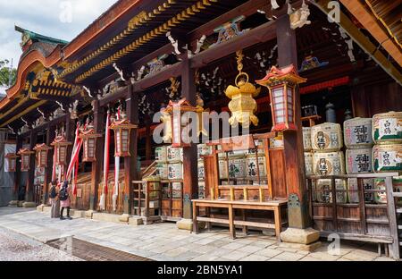 KYOTO, JAPAN - 17. OKTOBER 2019: Die Seitenansicht von Shaden oder Hauptheiligtum von Kitano Tenmangu Schrein mit dem Kazaridaru - die Dekoration Sake Fässer Stockfoto