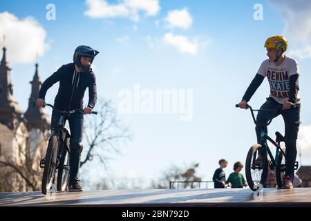 Lemberg, Ukraine - 12. März 2020: Junger Mann, der Tricks auf einem BMX-Fahrrad macht. BMX im Skatepark der Stadt. Teenager fahren mit dem Fahrrad in einem urbanen Bike- und Skatepark Stockfoto