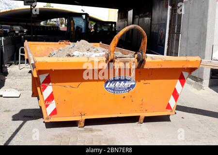 Orange skip für Bauschutt auf einer Baustelle; Deutschland; Europa Stockfoto