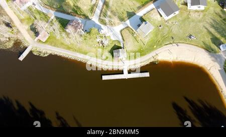 Luftaufnahme des Sees Borissowskoje, des Waldes und der Siedlung im Herbsttag, Borissowo, Leningrader Oblast, Russland Stockfoto